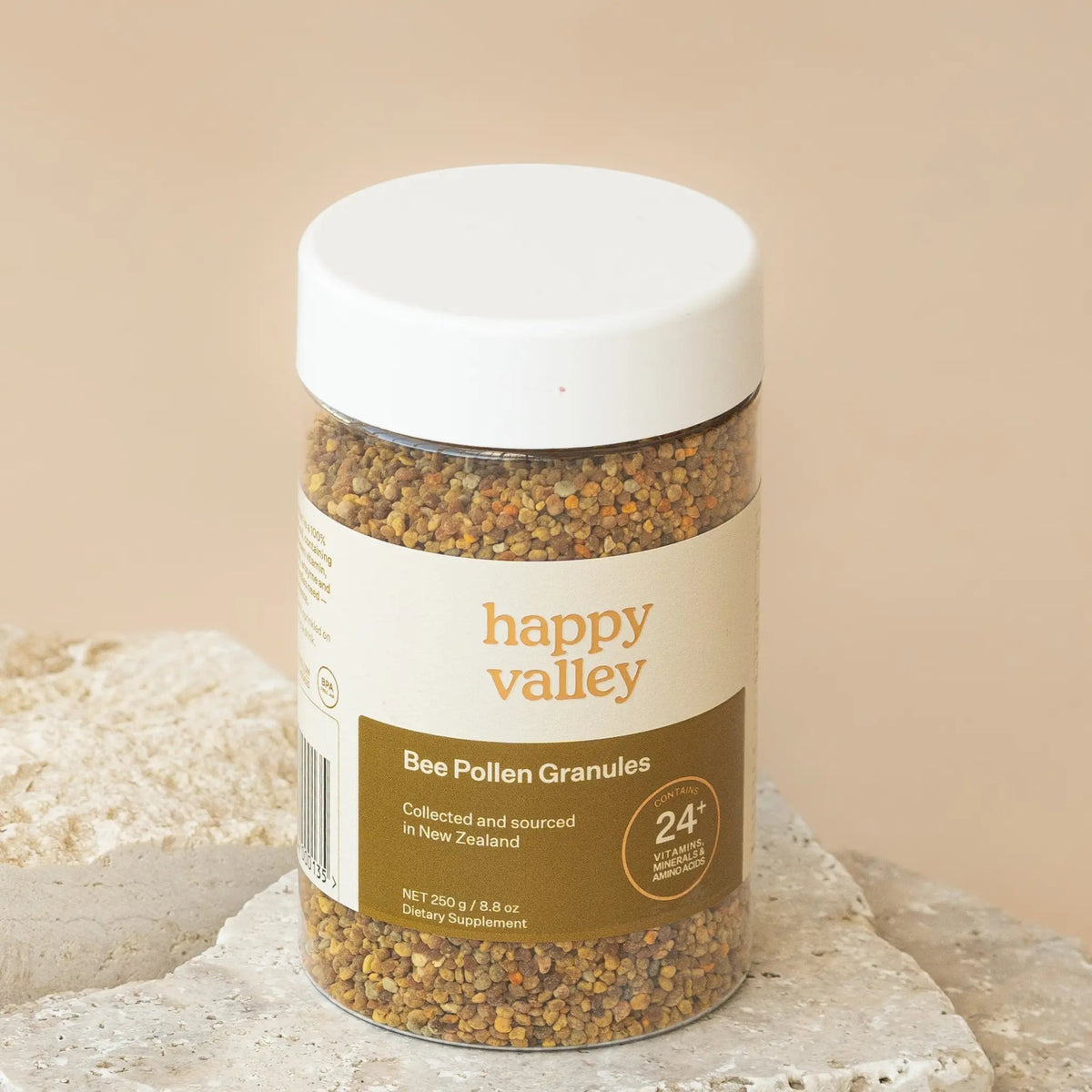 Happy Valley Bee Pollen Granules jar on a stone surface