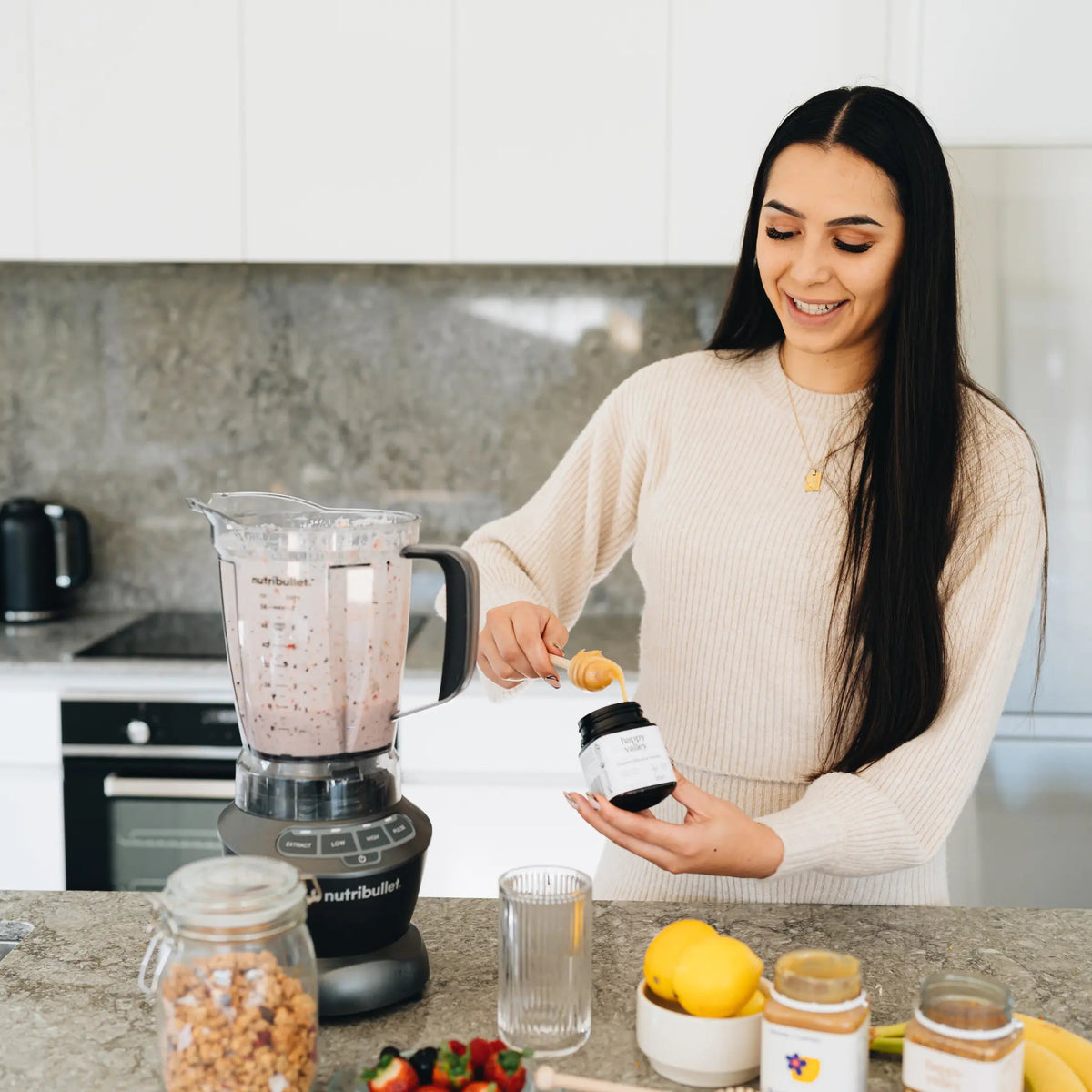 Person making a smoothie with Happy Valley Organic Mānuka Honey