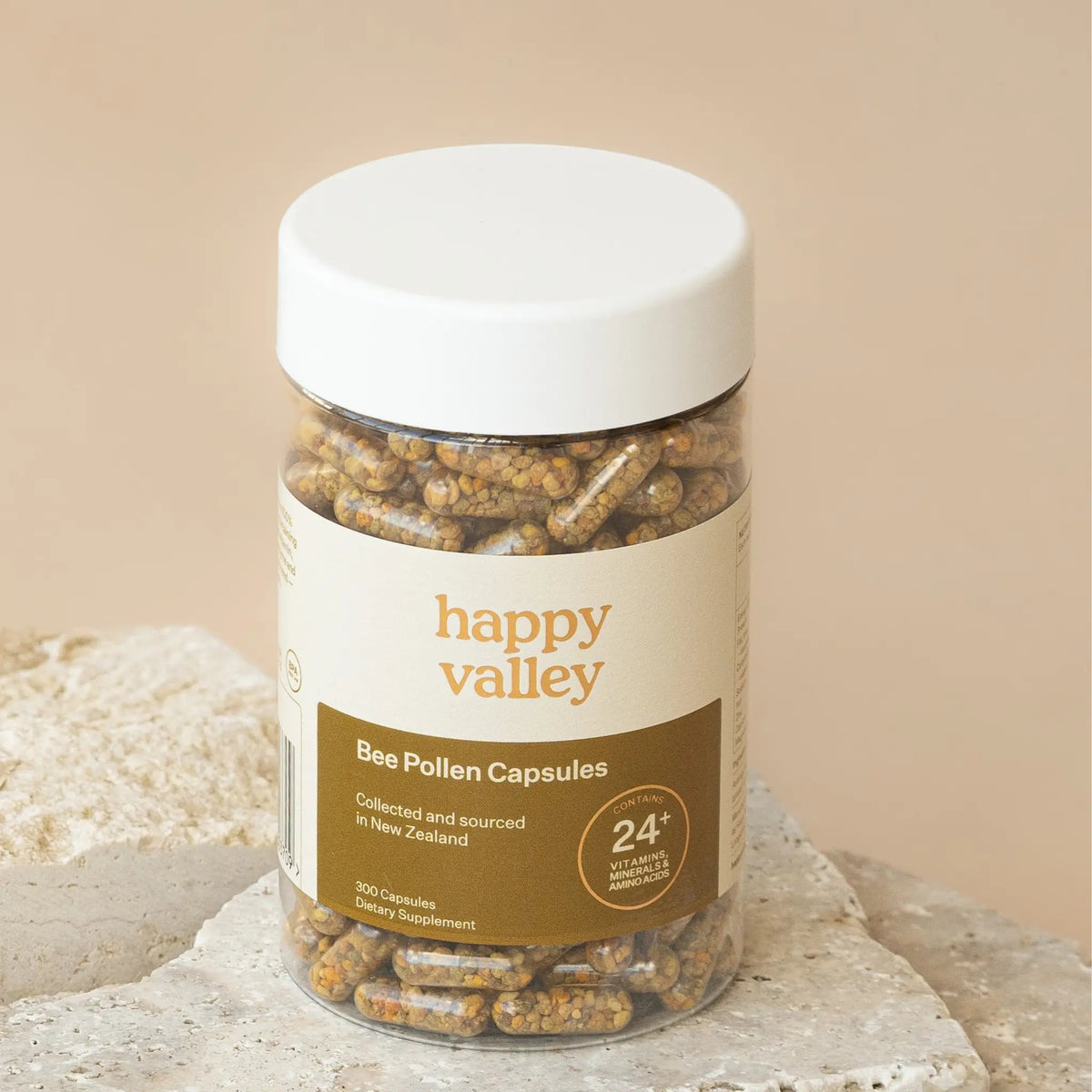 Happy Valley Bee Pollen Capsules jar on a stone surface