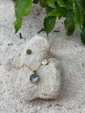 Pītau Moana Set pāua necklace and earrings on a stone
