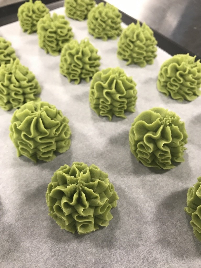 Rows of piped Lowrey Matcha butter cookies