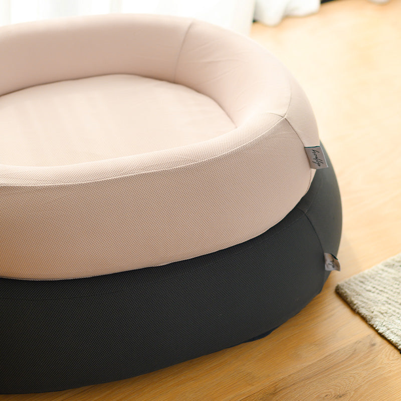 Pink and grey Brooklyn Nest dog beds stacked, close-up