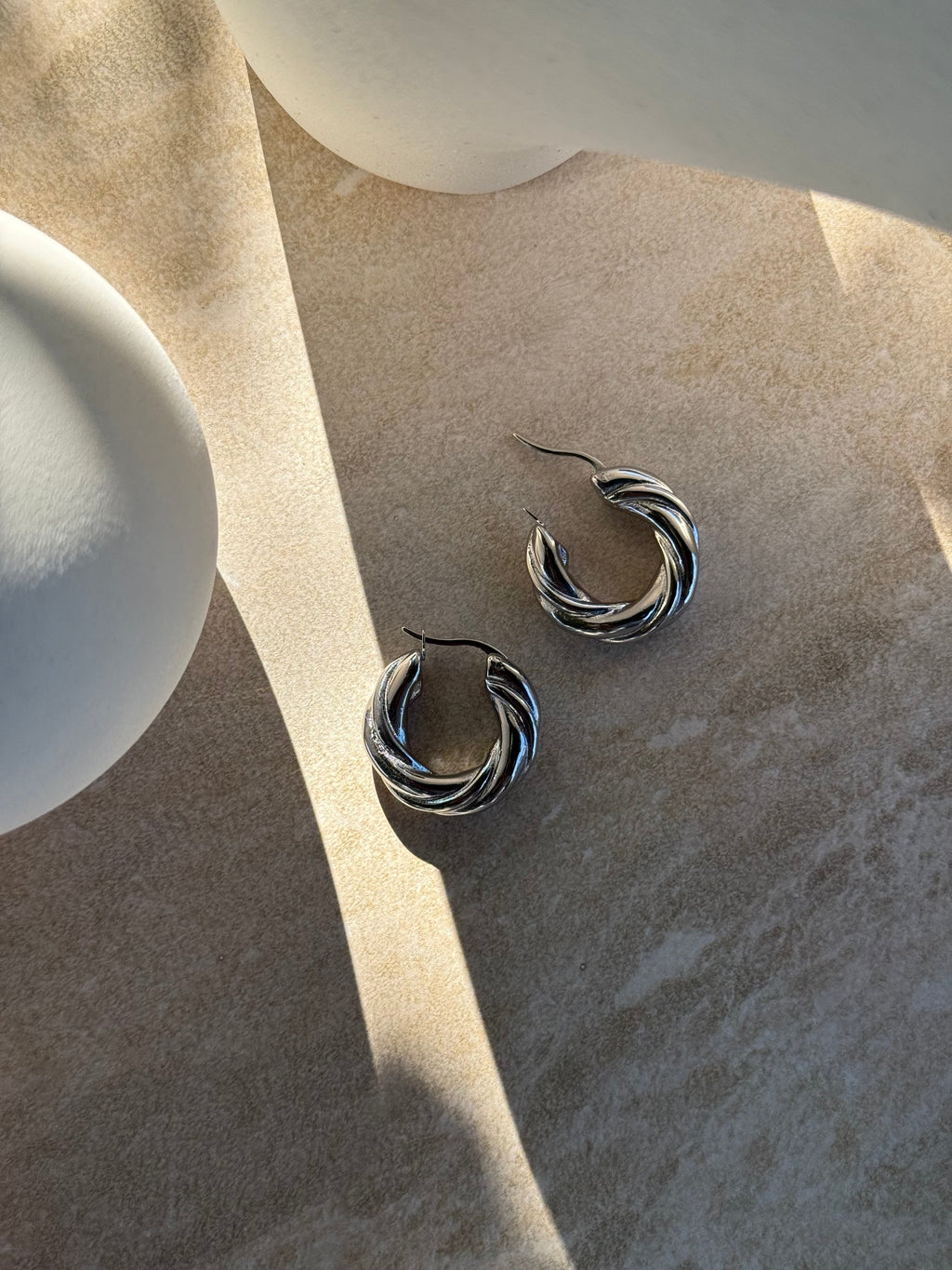 Tāwhirowhiro Silver Twisted Hoop Earrings close-up