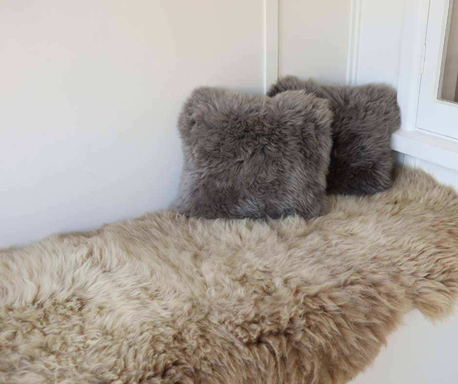 Grey sheepskin cushions on a sand sheepskin rug