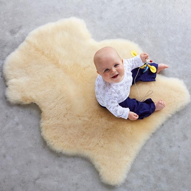 Baby sitting on a Classic Sheepskins Play Sheepskin Baby Rug