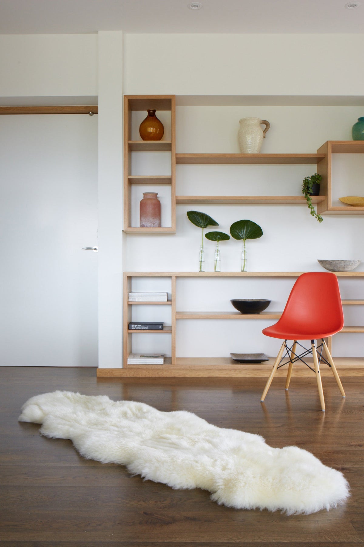 Natural white double sheepskin rug on a wooden floor