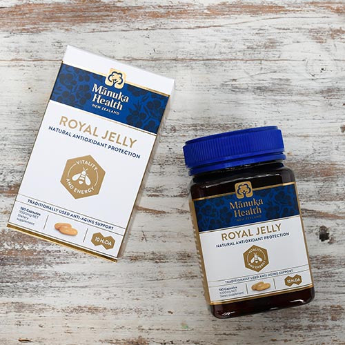 Manuka Health Royal Jelly capsules bottle and box on a wooden table