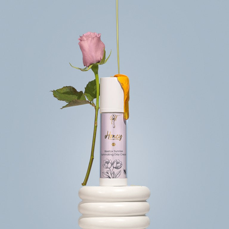 Beetox Sunrise Day Cream bottle with a pink rose