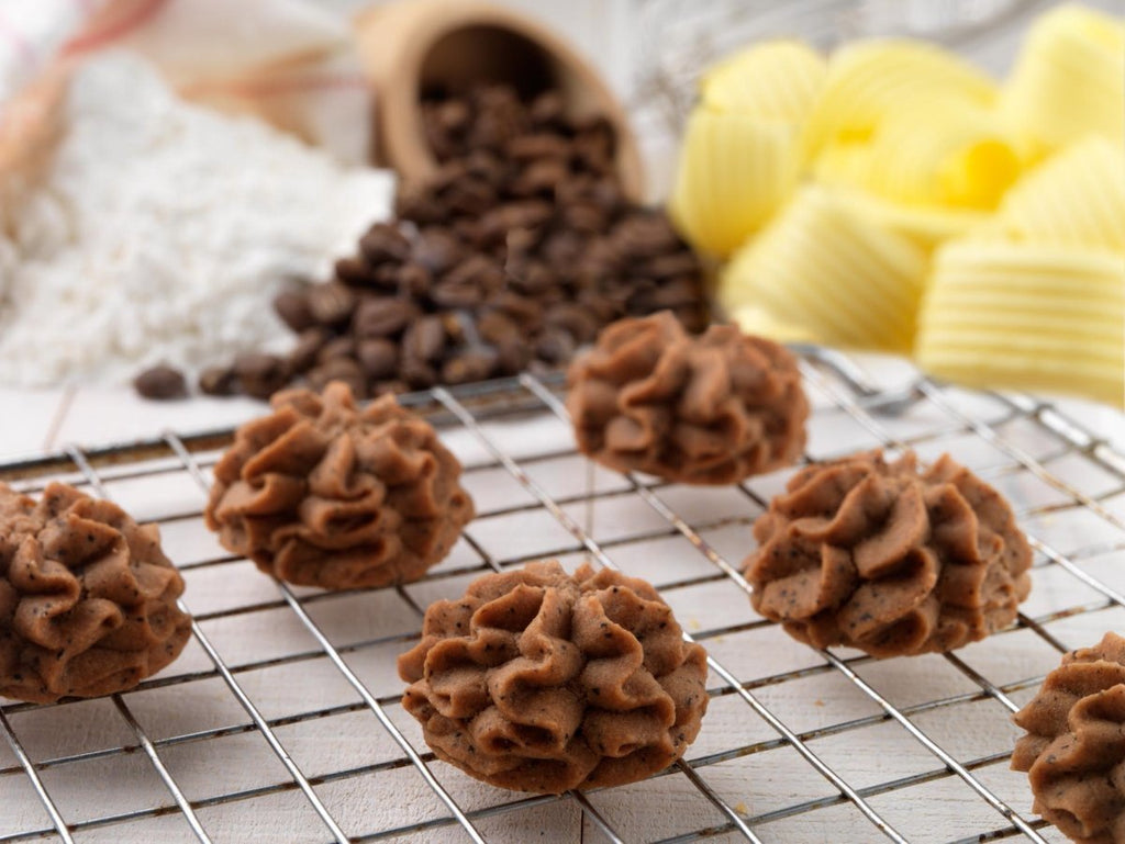 Lowrey Coffee butter cookies on a cooling rack with coffee beans and butter