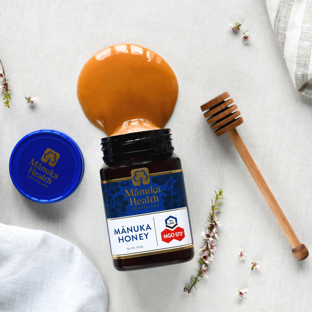 Manuka Health Original Manuka Honey MGO 573+ jar with a honey dipper