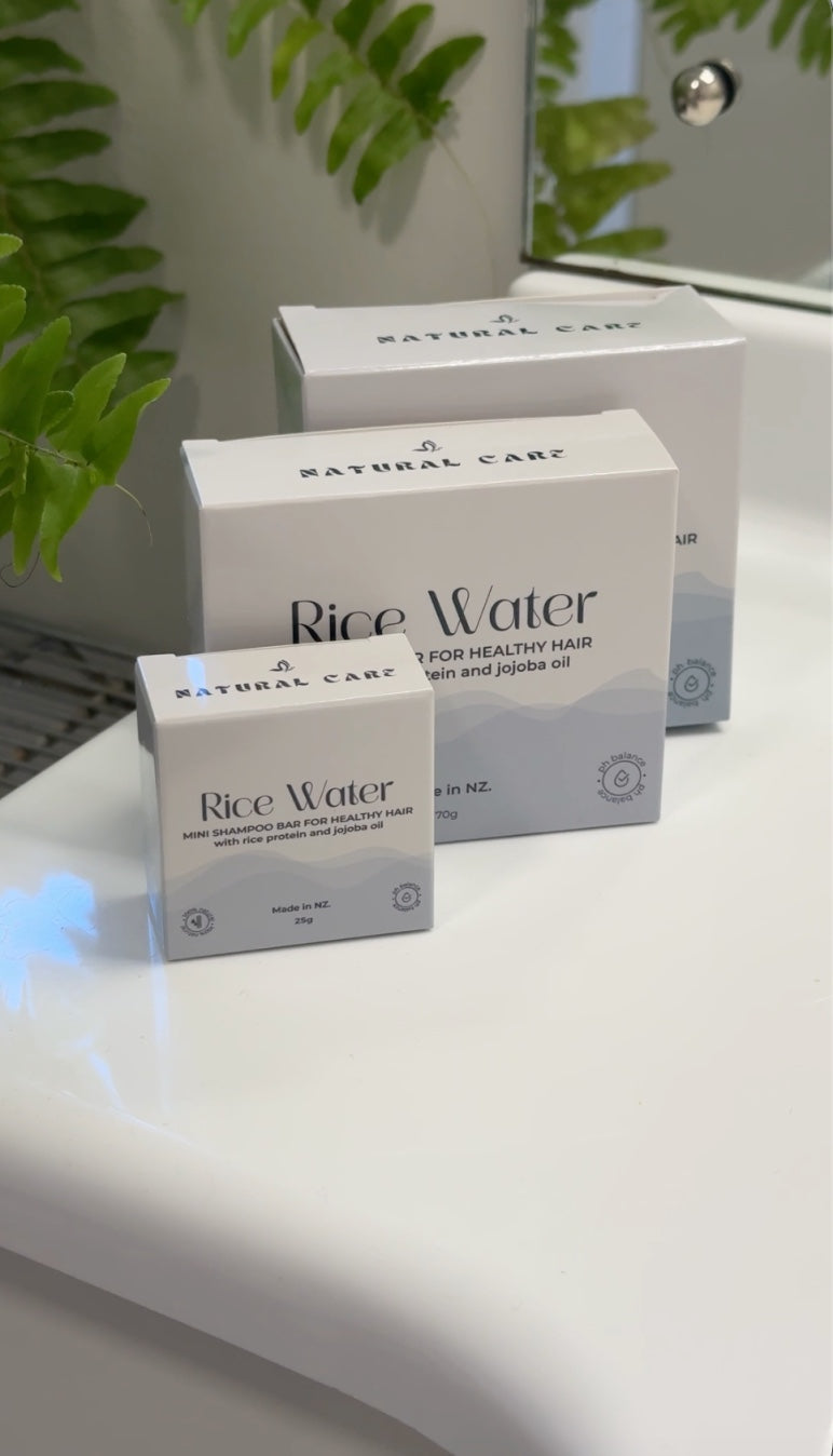 NaturalCare Rice Water boxes stacked with ferns