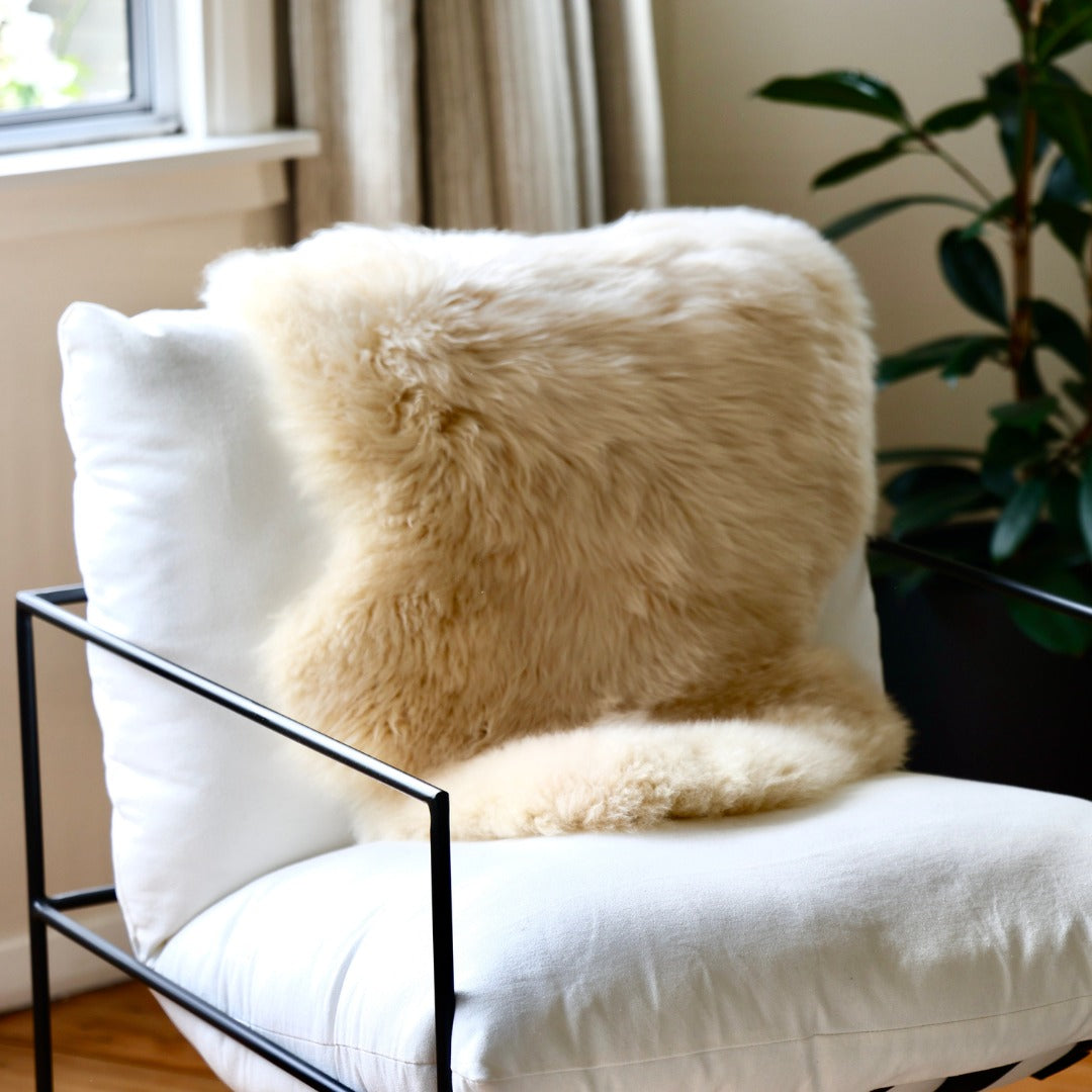 Honey single sheepskin rug over a white armchair