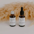 The Goods day face oil in a refill bottle and a dropper bottle by Bumble & Birdie, with pampas grass