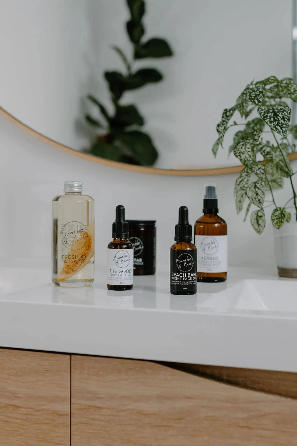 Winter Revival set bottles and candle on a bathroom vanity