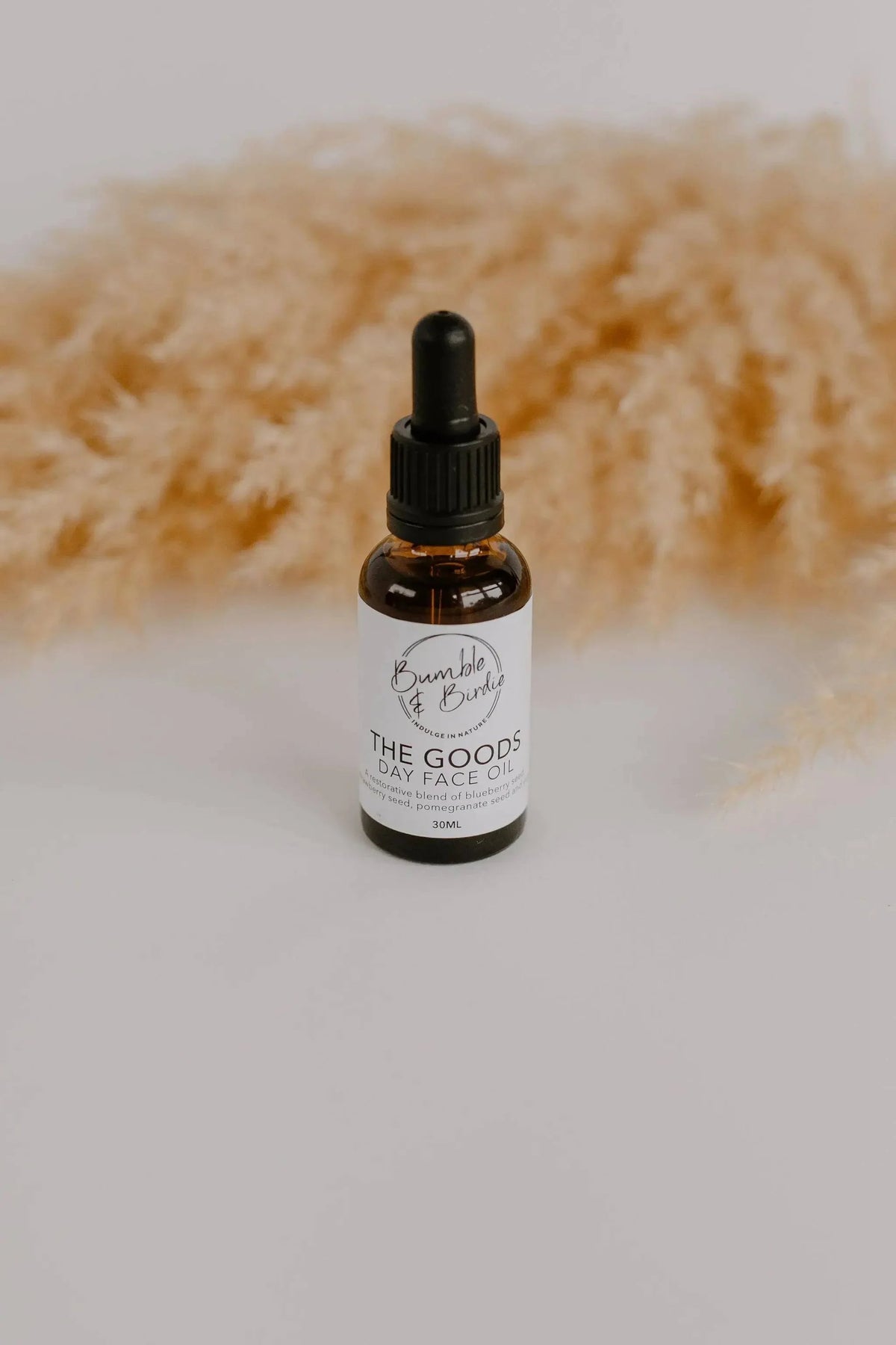 The Goods face oil dropper bottle from the Winter Revival set, with pampas grass