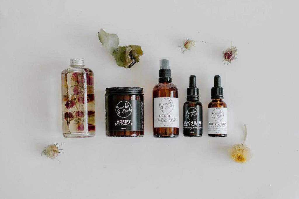 Winter Revival set laid out: body oil, jar candle, mist, serum and face oil