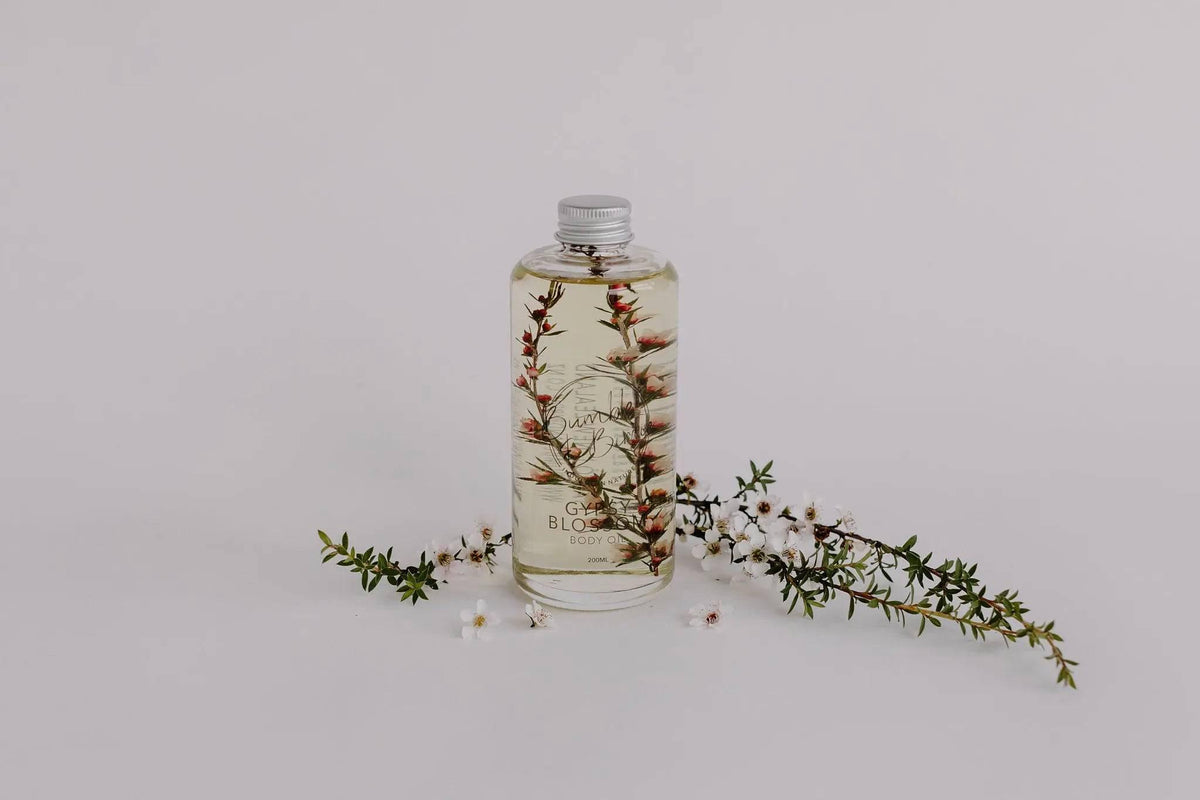 Gypsy Blossom body oil bottle with sprigs of small white flowers