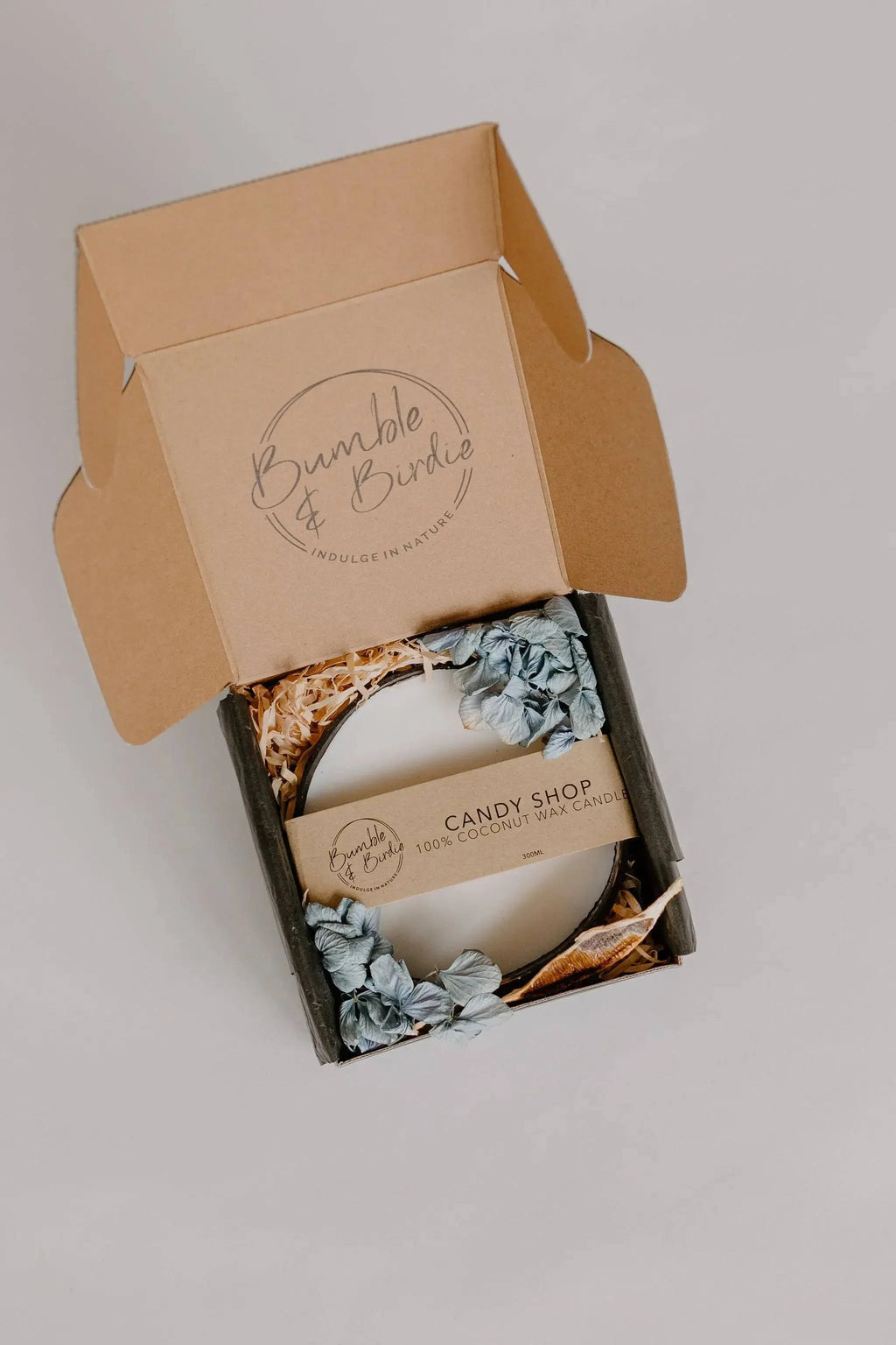 Candy Shop coconut candle in an open kraft Bumble & Birdie gift box