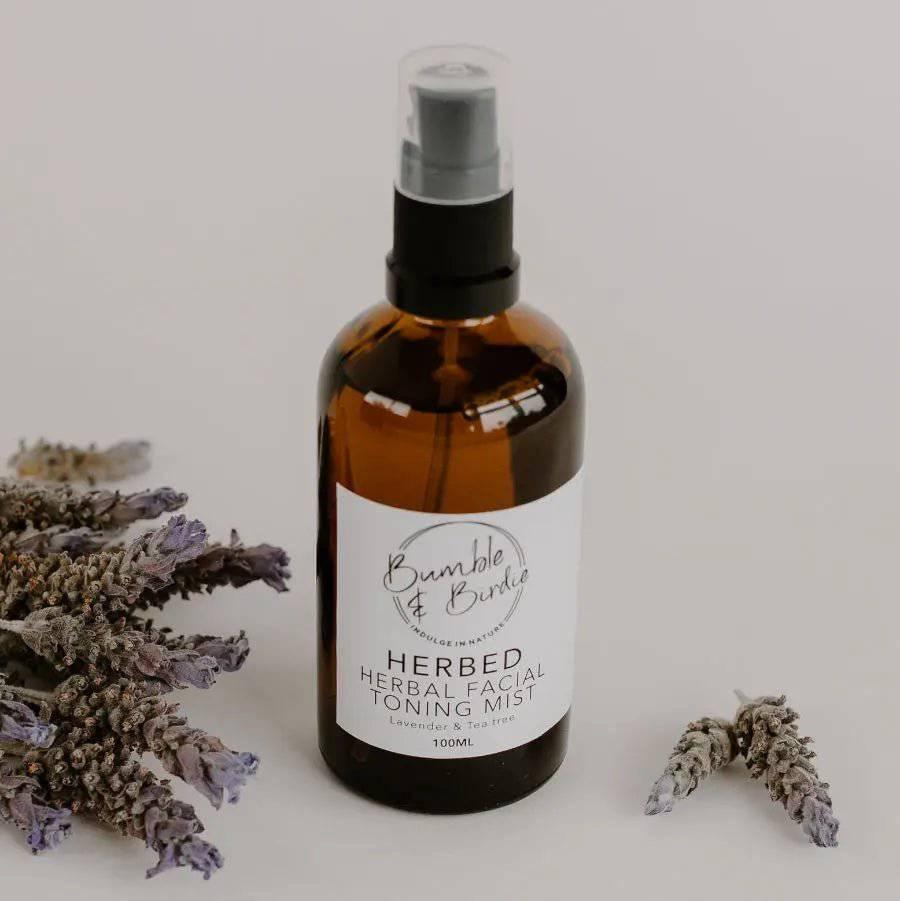 Close-up of Herbed facial toning mist in an amber spray bottle with dried lavender