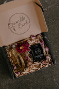 Pick Me Up Selfcare Ritual Set in an open Bumble & Birdie gift box with a jar candle and body oil