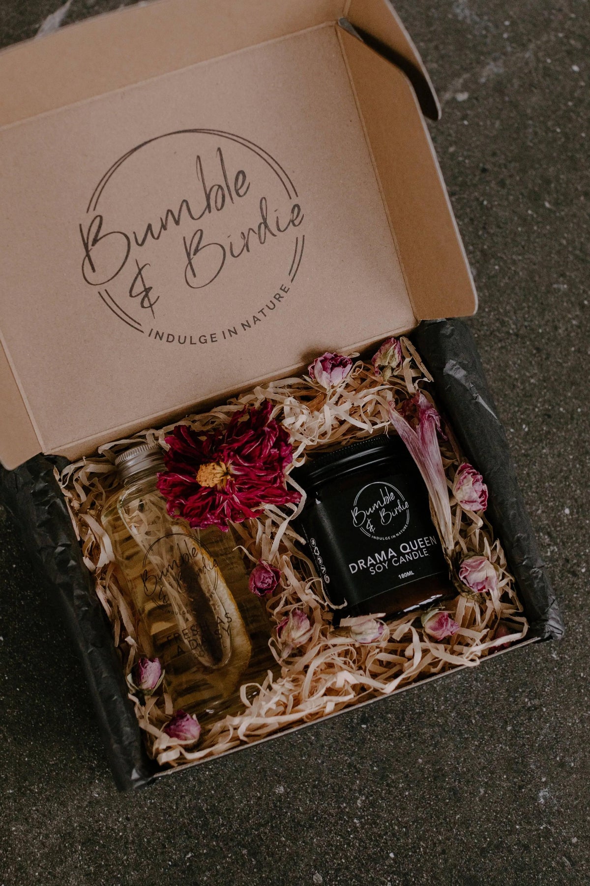 Pick Me Up Selfcare Ritual Set in an open Bumble & Birdie gift box with a jar candle and body oil