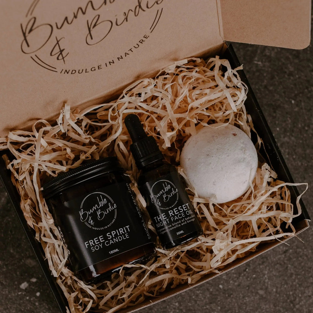 Autumn Reset Seasonal Ritual Set in an open Bumble & Birdie box with a jar candle, face oil and bath bomb