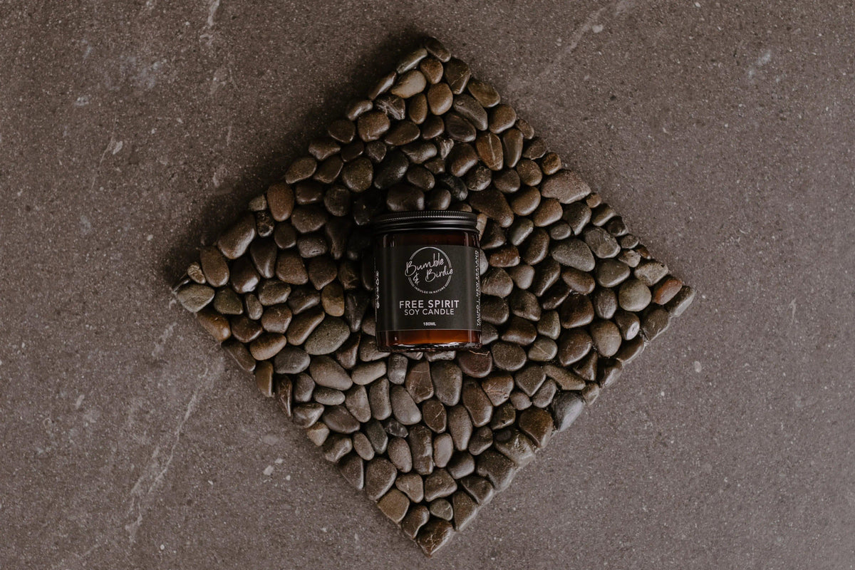 Stone & Soy Retreat (nui) jar candle on a stone mat, from above