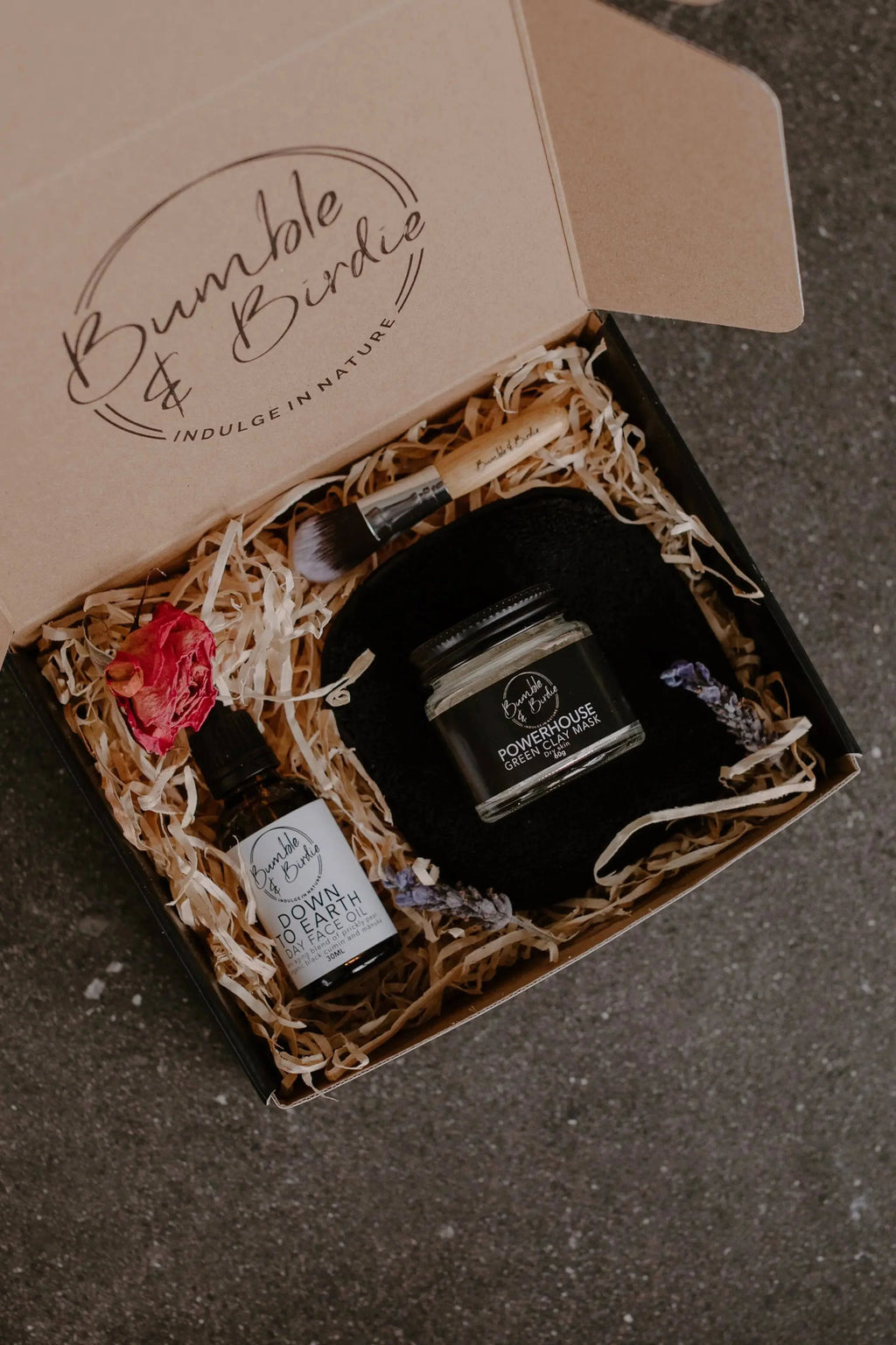Powerhouse Ritual Set in an open Bumble & Birdie gift box with a clay mask, face oil and brush