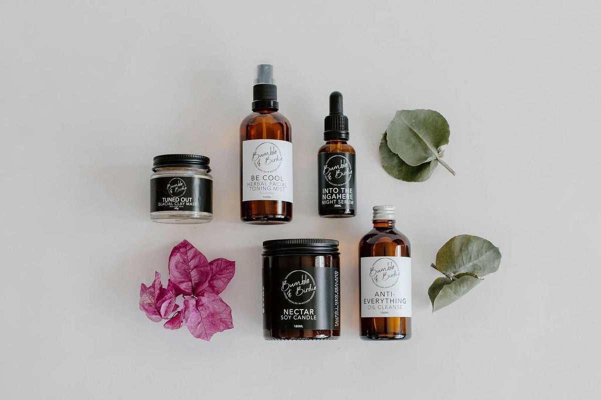 Summer Daze set laid out: facial mist, serum, clay mask, oil cleanser and Nectar jar candle