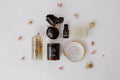 The Art of Bath Ritual Set laid out: body oil, jar candle, essential oil, soap dish and body bar