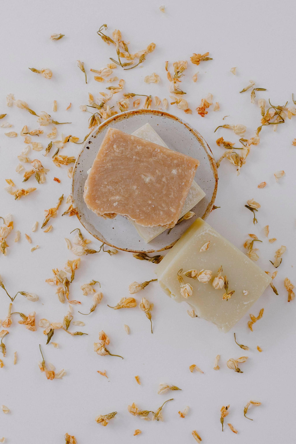 Earth Cleanse Gift Set: body bar on a pottery soap dish among dried petals