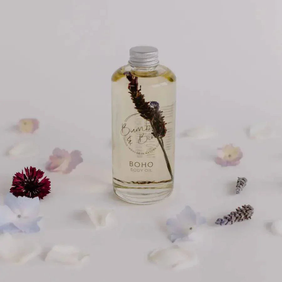Boho body and bath oil bottle by Bumble & Birdie among scattered petals and lavender