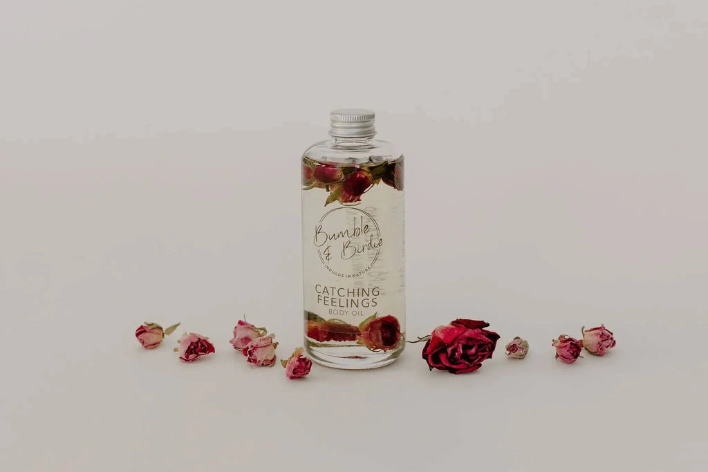 Catching Feelings body and massage oil bottle with scattered rose buds