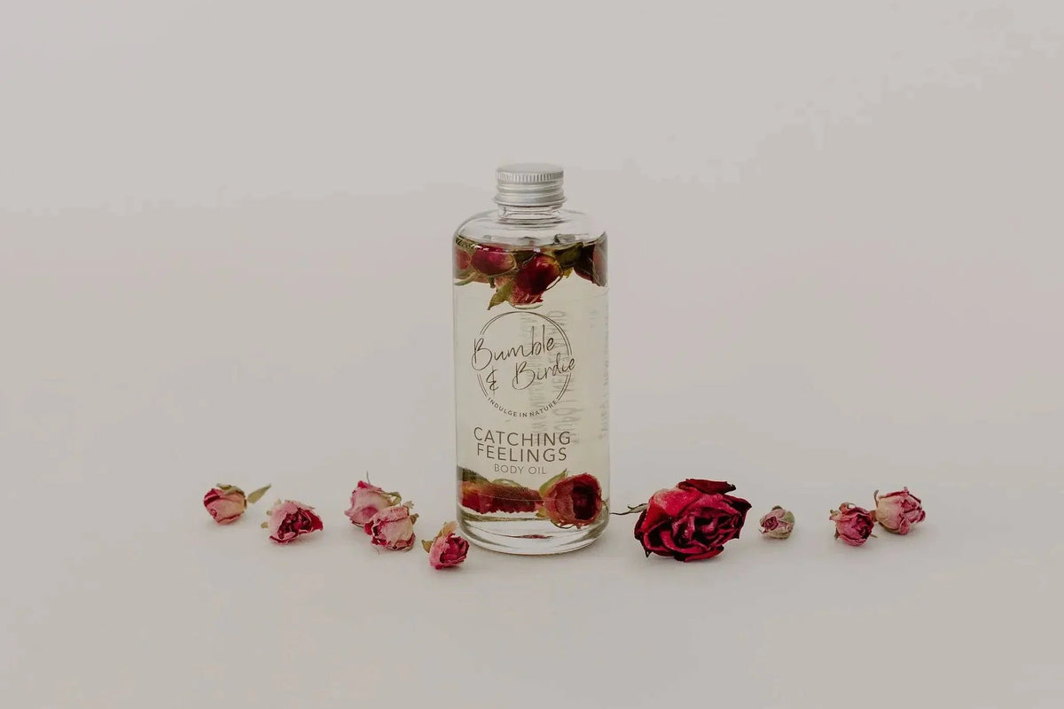 Catching Feelings body and massage oil bottle with scattered rose buds