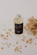 Im Vanilla Baby bath and body oil in a clear bottle by Bumble & Birdie, with dried flowers