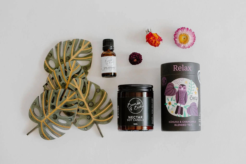 Sweet Nothings set laid out: Nectar jar candle, spearmint essential oil, Oku relaxation tea and resin leaf coasters