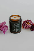 Bloom soy candle in an amber glass jar by Bumble & Birdie, with pink flowers