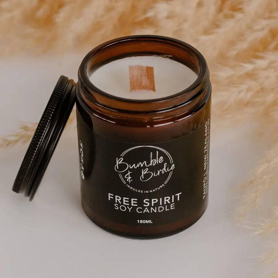 Close-up of an open Free Spirit soy candle in an amber glass jar