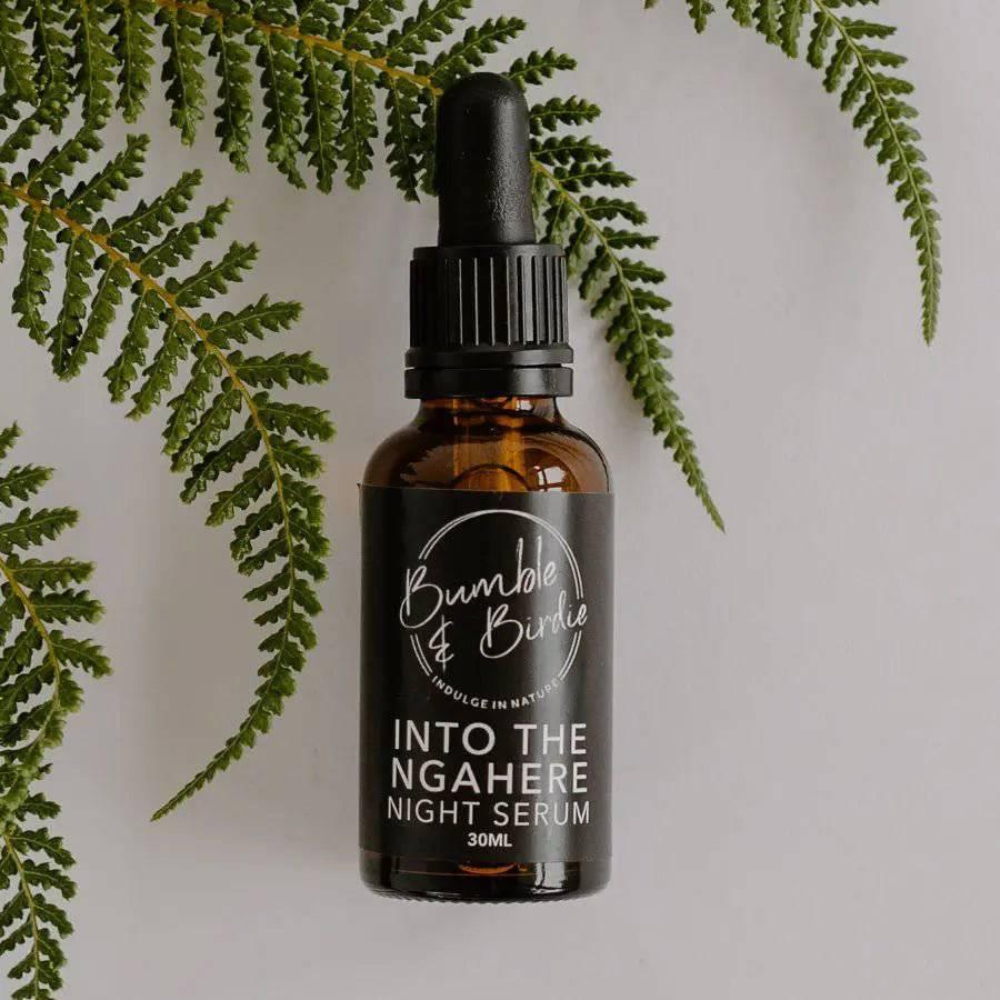 Into the Ngahere night serum in a dropper bottle by Bumble & Birdie, against green ferns
