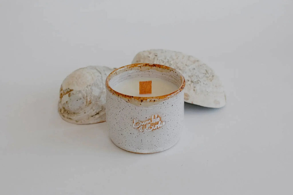 Alchemy Earth soy candle in a speckled handmade clay bowl with a wood wick