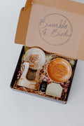 Devine Feminine set in an open gift box with a clay diffuser, orange soap dish, essential oil and soap