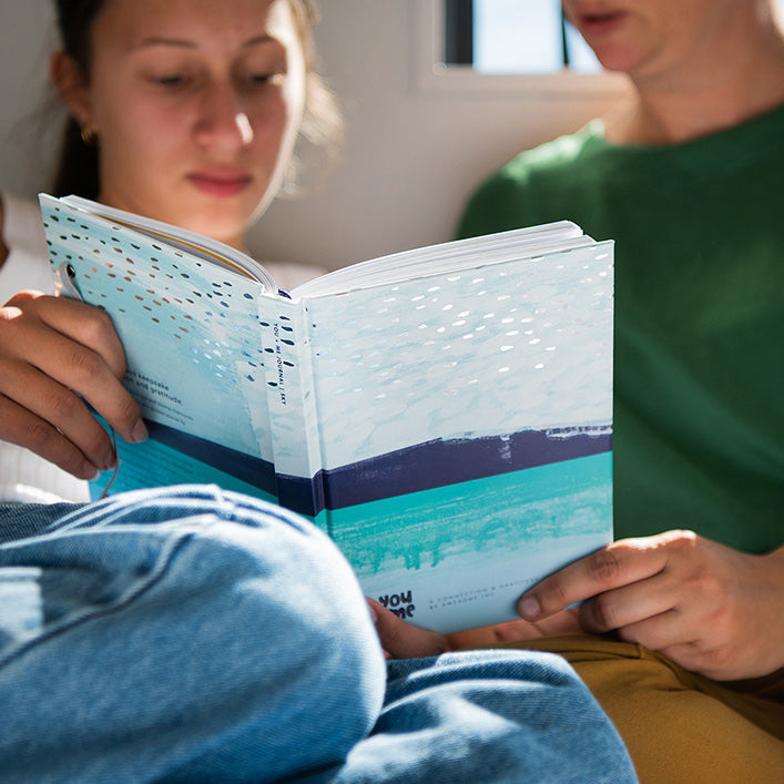 Parent and child reading a You + ME Connection Journal