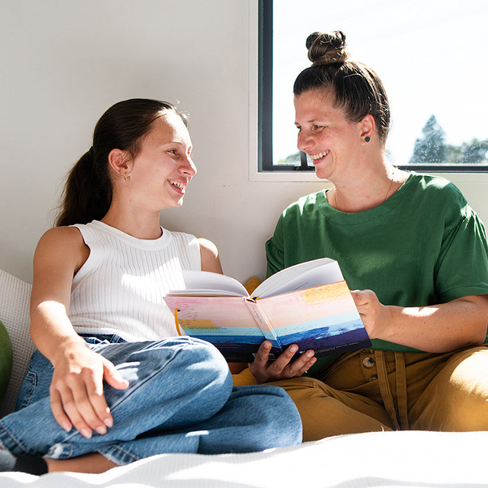 Parent and daughter sharing a You + ME Connection Journal