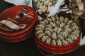 Open red tin of Lowrey Black Sesame butter cookies