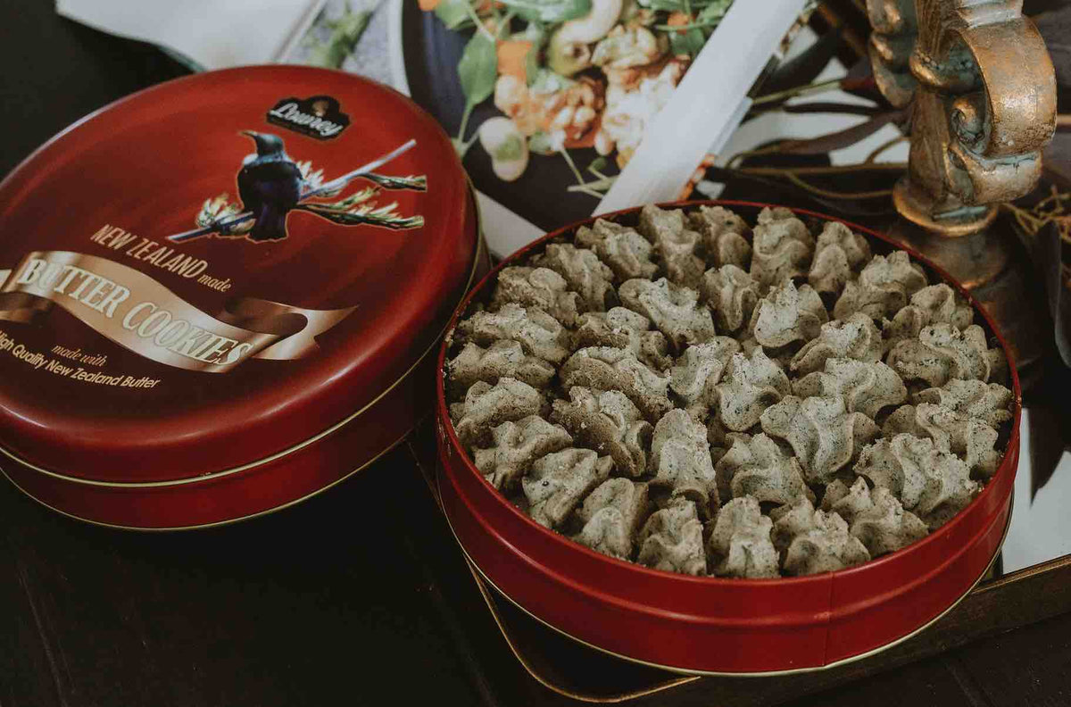 Open red tin of Lowrey Black Sesame butter cookies