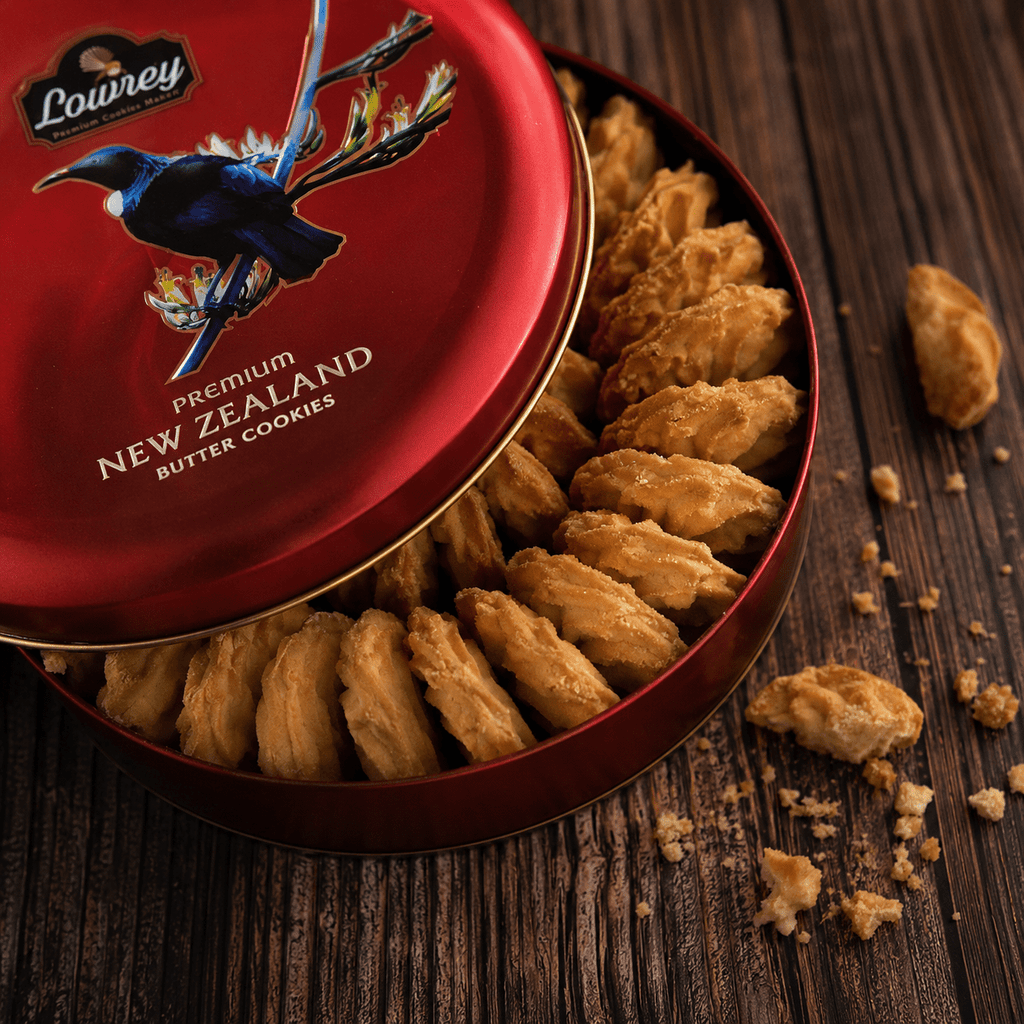 Open red tin of Lowrey Original butter cookies on dark wood