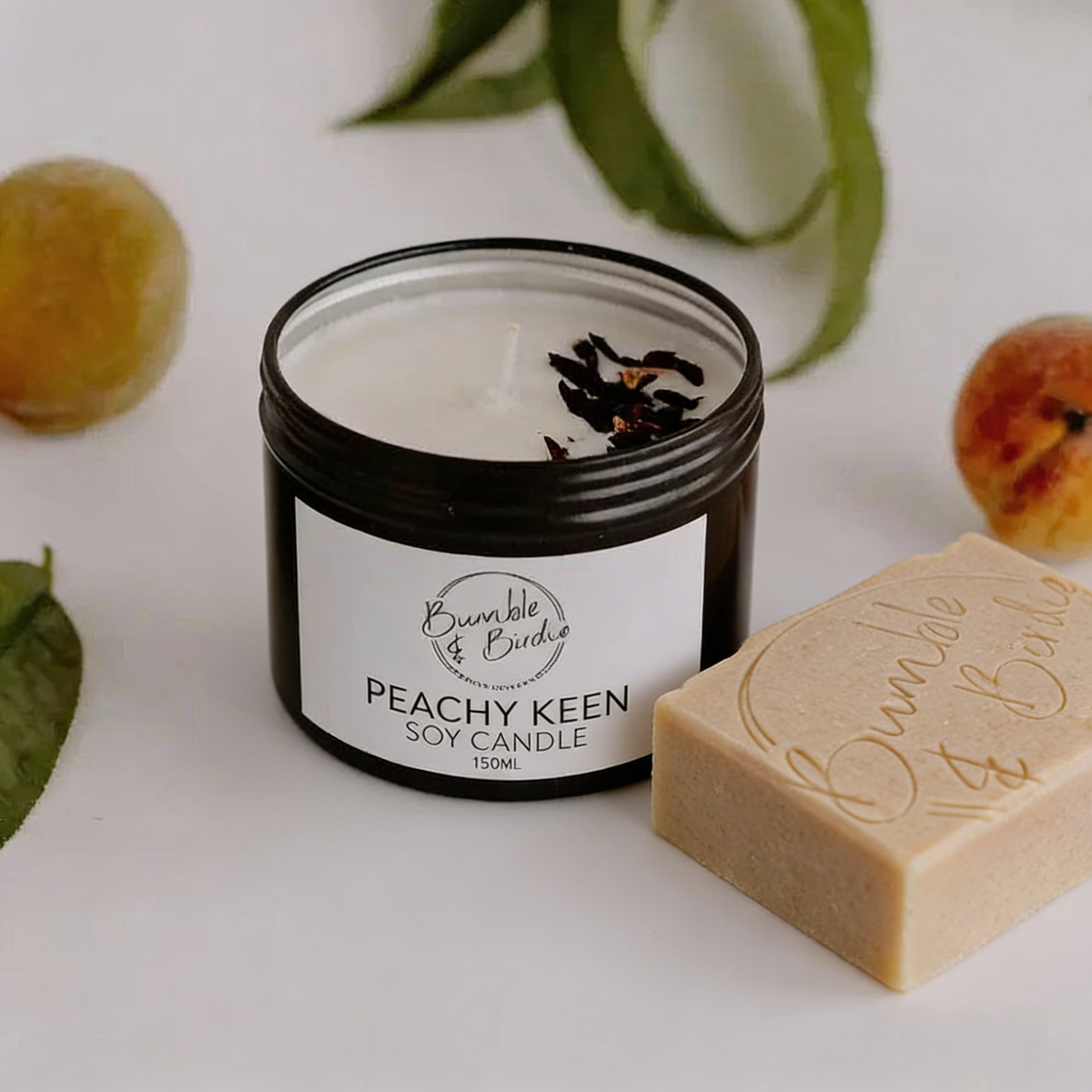 Peachy Keen Gift Set: Peachy Keen soy tin candle beside a Bumble & Birdie body bar, with peaches