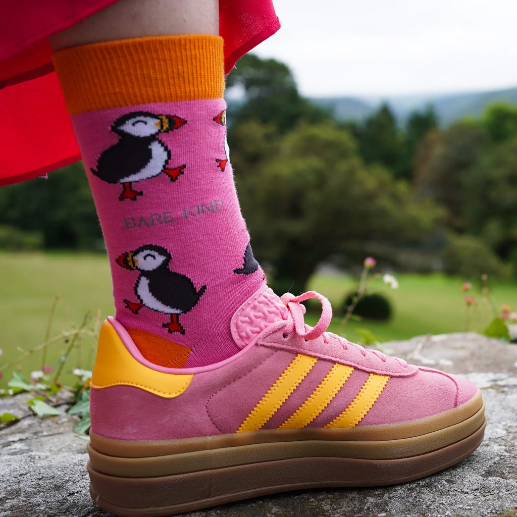 Person wearing pink Barekind puffin socks with pink sneakers