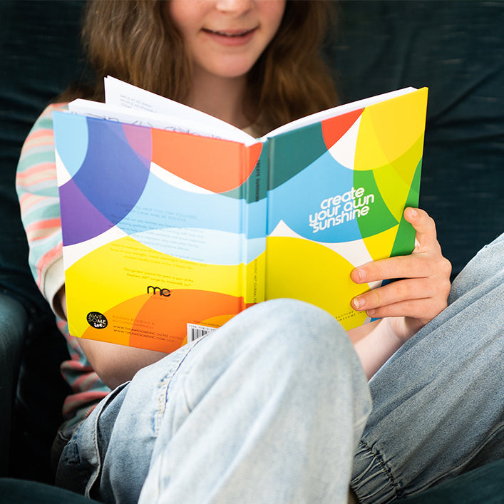 Teenager reading a Resilient ME teen journal
